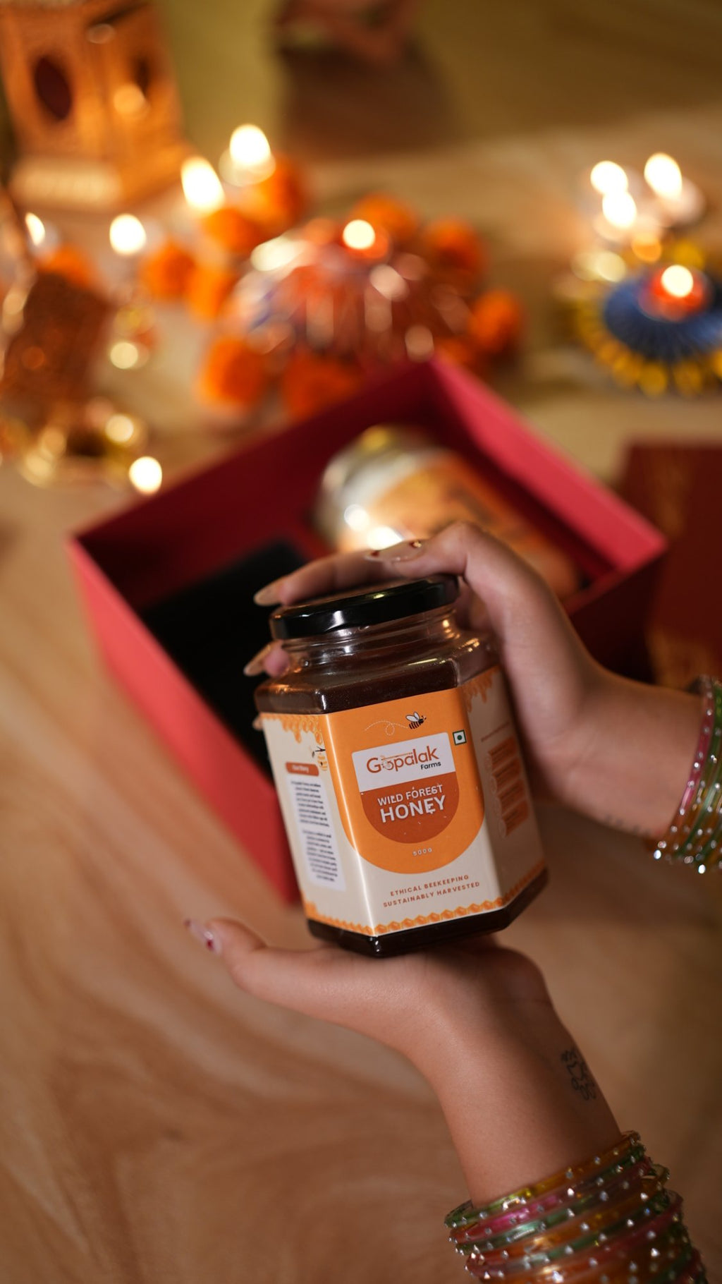Wild forest honey jar held over the Classic Hamper gift box