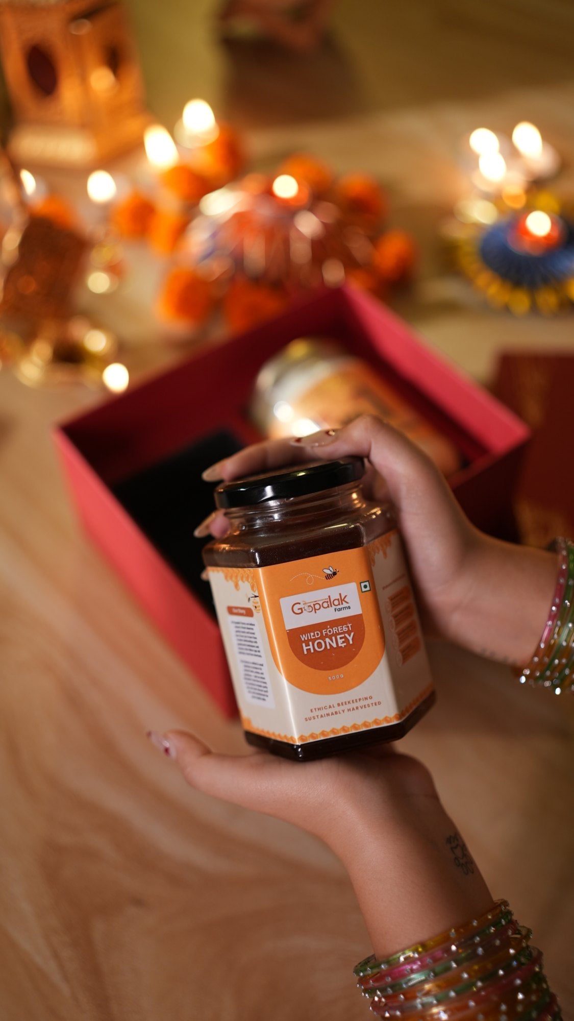 Wild forest honey jar held over the Classic Hamper gift box