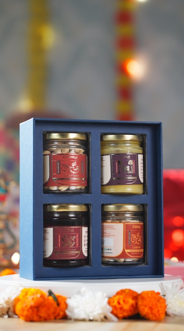 Festive Grace Hamper blue box with four jars of ghee, honey, almonds and cashews